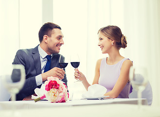 Image showing young couple with glasses of wine at restaurant