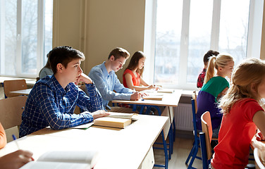 Image showing group of students with books writing school test