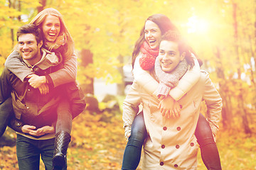 Image showing smiling friends having fun in autumn park