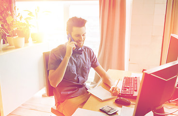 Image showing happy creative male worker calling on smarphone