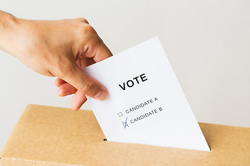 Image showing man putting his vote into ballot box on election