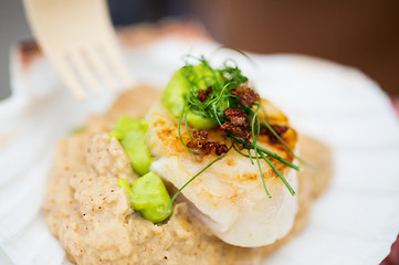 Image showing close up of scallop snack with garnish