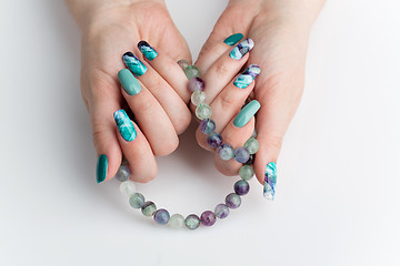 Image showing Closeup of woman hands with colorful nails