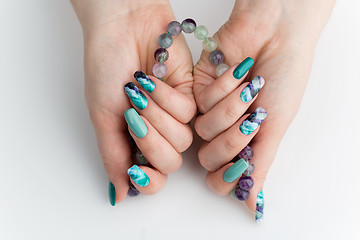 Image showing Closeup of woman hands with colorful nails