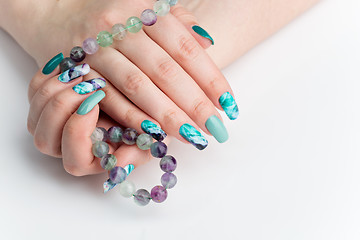 Image showing Closeup of woman hands with colorful nails