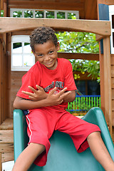 Image showing editorial young Nicaraguan boy playing on slide Big Corn Island 