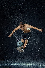 Image showing Water drops around football player