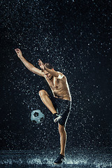 Image showing Water drops around football player