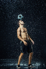 Image showing Water drops around football player