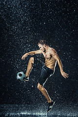 Image showing Water drops around football player