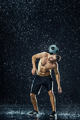 Image showing Water drops around football player