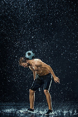 Image showing Water drops around football player