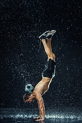 Image showing Water drops around football player