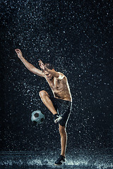 Image showing Water drops around football player