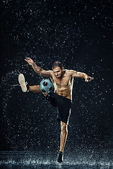 Image showing Water drops around football player