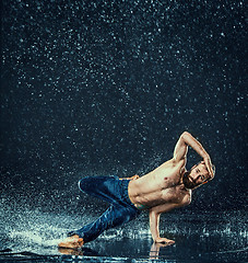 Image showing The male break dancer in water.