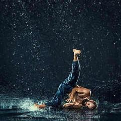 Image showing The male break dancer in water.