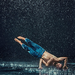 Image showing The male break dancer in water.