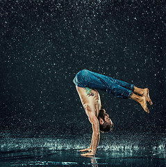 Image showing The male break dancer in water.