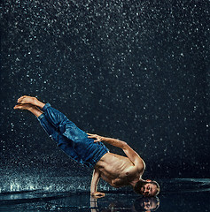 Image showing The male break dancer in water.