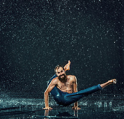 Image showing The male break dancer in water.