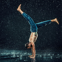 Image showing The male break dancer in water.