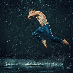 Image showing The male break dancer in water.