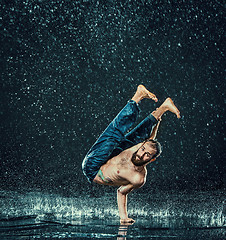 Image showing The male break dancer in water.