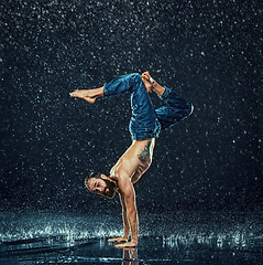 Image showing The male break dancer in water.