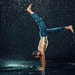 Image showing The male break dancer in water.