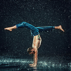 Image showing The male break dancer in water.