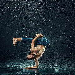 Image showing The male break dancer in water.