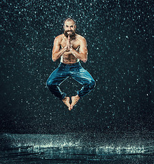 Image showing The male break dancer in water.