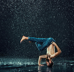 Image showing The male break dancer in water.