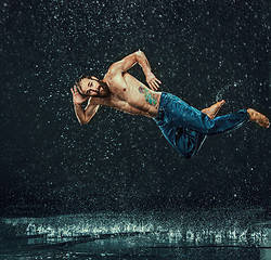 Image showing The male break dancer in water.