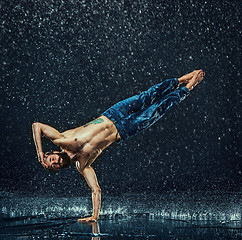 Image showing The male break dancer in water.