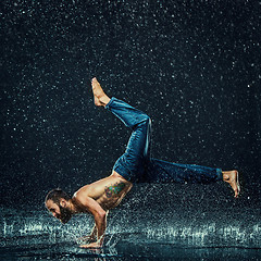 Image showing The male break dancer in water.