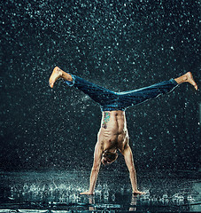 Image showing The male break dancer in water.