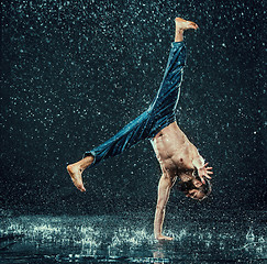 Image showing The male break dancer in water.