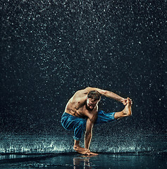 Image showing The male break dancer in water.