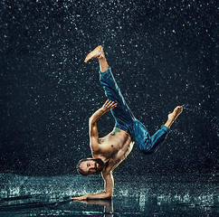 Image showing The male break dancer in water.