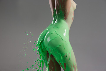 Image showing The beautiful woman with green liquid paint over her body