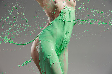 Image showing The beautiful woman with green liquid paint over her body