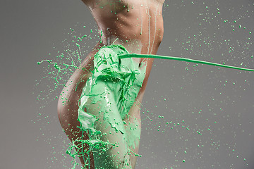 Image showing The beautiful woman with green liquid paint over her body