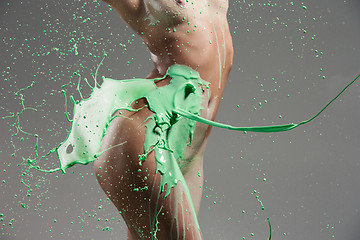 Image showing The beautiful woman with green liquid paint over her body