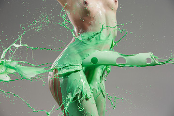 Image showing The beautiful woman with green liquid paint over her body