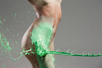 Image showing The beautiful woman with green liquid paint over her body