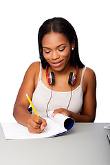 Image showing Happy teenage student doing homework