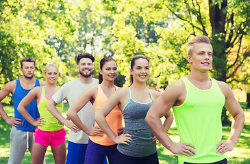 Image showing group of happy friends or sportsmen outdoors