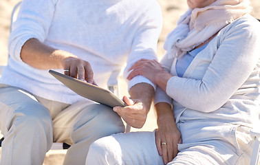 Image showing close up of senior couple with tablet pc on beach